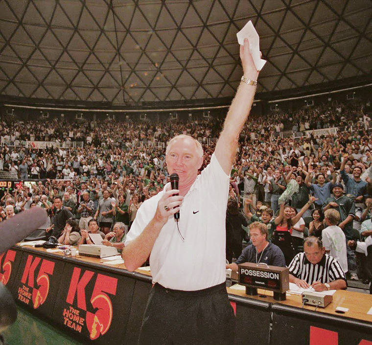 STAR-ADVERTISER FILE / 1998
                                Riley Wallace announces to the Stan Sheriff Center crowd that the Rainbows will host a third NIT game.