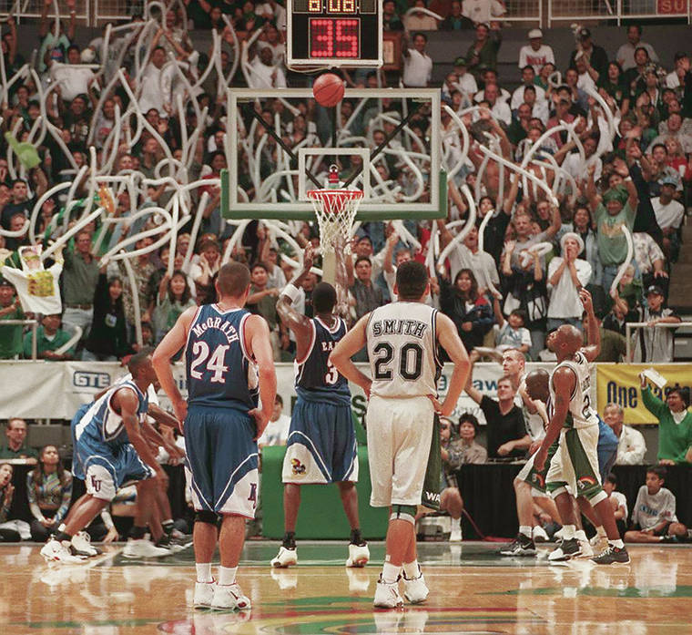 STAR-ADVERTISER / 1997
                                UH basketball fans at the Stan Sheriff Center tried to distract a Kansas player during a free throw.