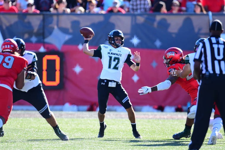 STEVEN ERLER / SPECIAL TO THE HONOLULU STAR-ADVERTISER
                                Hawaii quarterback Chevan Cordeiro (12) tossed the ball during the first half of a game between UNLV and Hawaii today at Sam Boyd Stadium in Las Vegas, Nevada.