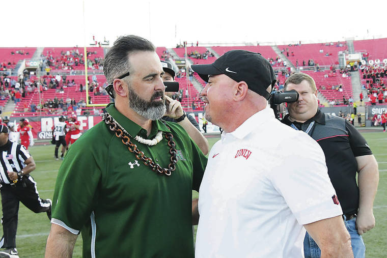 STEVEN ERLER / SPECIAL TO THE STAR-ADVERTISER
                                Hawaii head coach Nick Rolovich met with UNLV head coach Tony Sanchez after Saturday’s game at Sam Boyd Stadium in Las Vegas. The Rainbow Warriors will play in a bowl game for the third time in Rolovich’s four years as coach.