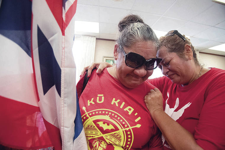 CINDY ELLEN RUSSELL / CRUSSELL@STARADVERTISER.COM
                                Fisiipeau Drummondo, left, and Lulu Esquivel hugged Friday after they were told by city spokesman Andrew Pereira that Mayor Kirk Caldwell couldn’t meet with the group protesting the Kahuku wind farm development.