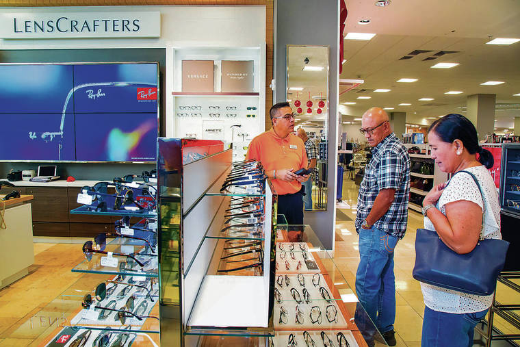 KAT WADE / SPECIAL TO THE STAR-ADVERTISER
                                Optician Bill Schulte, left, talked with customers Manny and Rose Benitez at the new “Lens Crafters,” one of the upgrades in the Ala Moana Center Macy’s.