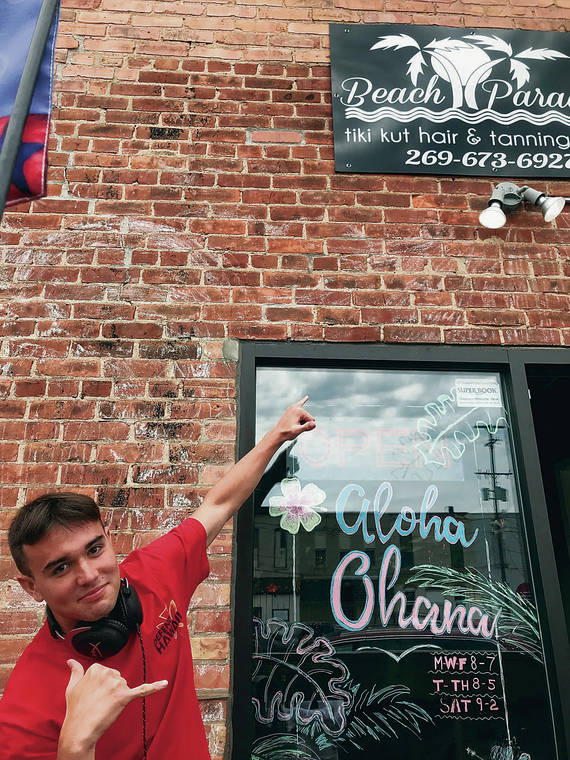 Bert 
Kobayashi III threw shakas in front of the Beach Paradise Tiki Kut, Hair & Tanning Salon in Allegan, Mich., in June. He opted out of getting a fresh do and stuck with his Oahu tan and haircut. Photo by Peter Boylan.