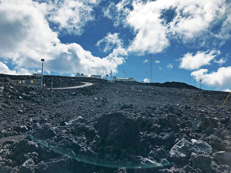 LEILA FUJIMORI / LFUJIMORI@STARADVERTISER.COM
                                A view of the two observatories on the slopes of Mauna Loa. There is a gate blocking public access, but some visitors go around it.