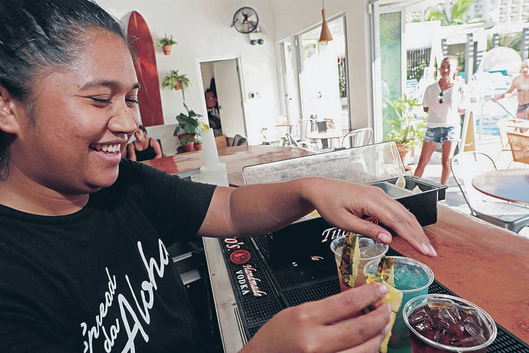 JAMM AQUINO / JAQUINO@STARADVERTISER.COM
                                Tamy Koni, manager at Aloha Aroma Caffe, mixes cocktails for patrons during happy hour on Oct. 10.