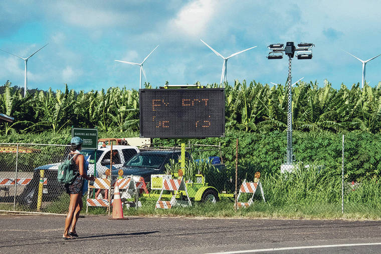 CRAIG T. KOJIMA / CKOJIMA@STARADVERTISER.COM
                                There have been many recent protests, and arrests, over AES Na Pua Makani’s wind farm project. Shown last month, above, were smaller turbines from another, existing wind project in Kahuku, seen in the distance over banana trees.