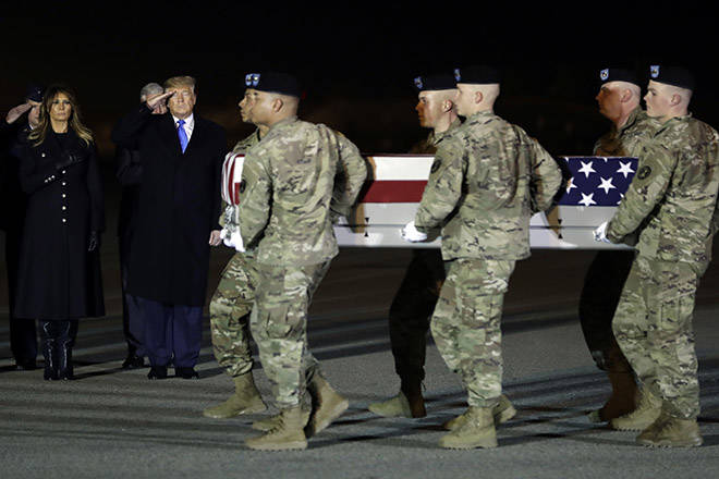 ASSOCIATED PRESS
                                President Donald Trump and first lady Melania Trump watched today as an Army carry team moved a transfer case containing the remains of Chief Warrant Officer Kirk T. Fuchigami Jr. of Keaau at Dover Air Force Base, Del. According to the Department of Defense, Fuchigami died in Afghanistan when his helicopter crashed while providing security for troops on the ground in eastern Logar province.