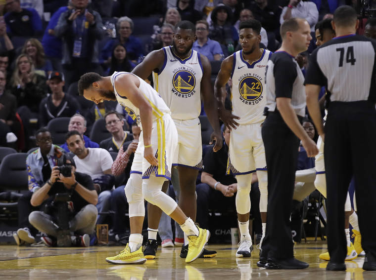 ASSOCIATED PRESS
                                Golden State Warriors’ Stephen Curry, left, grimaces after Phoenix Suns’ Aron Baynes fell onto him during the second half of an NBA basketball game Wednesday in San Francisco.