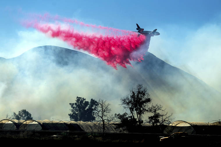 ASSOCIATED PRESS
                                An air tanker drops retardant as the Maria Fire approaches Santa Paula, Calif. According to Ventura County Fire Department, the blaze has scorched more than 8,000 acres and destroyed at least two structures.