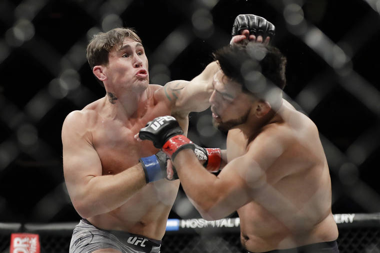 ASSOCIATED PRESS
                                Britain’s Darren Till, left, punched Kelvin Gastelum during the second round of a middleweight mixed martial arts bout at UFC 244 on Saturday, in New York. Till won the fight.