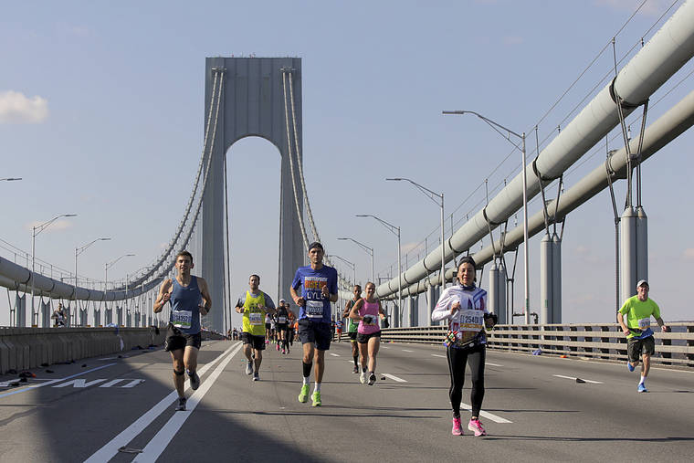 ASSOCIATED PRESS
                                Runners made their way across the Verrazano-Narrows Bridge during the start of the New York City Marathon, today, in New York.