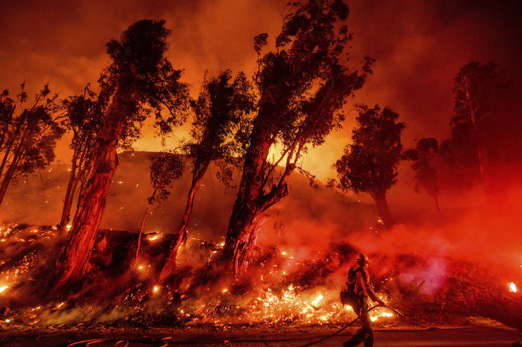 ASSOCIATED PRESS
                                Flames from a backfire consumed a hillside, Nov. 1, as firefighters battled the Maria Fire in Santa Paula, Calif. According to the Ventura County Fire Department, the blaze has scorched more than 8,000 acres and destroyed at least two structures.