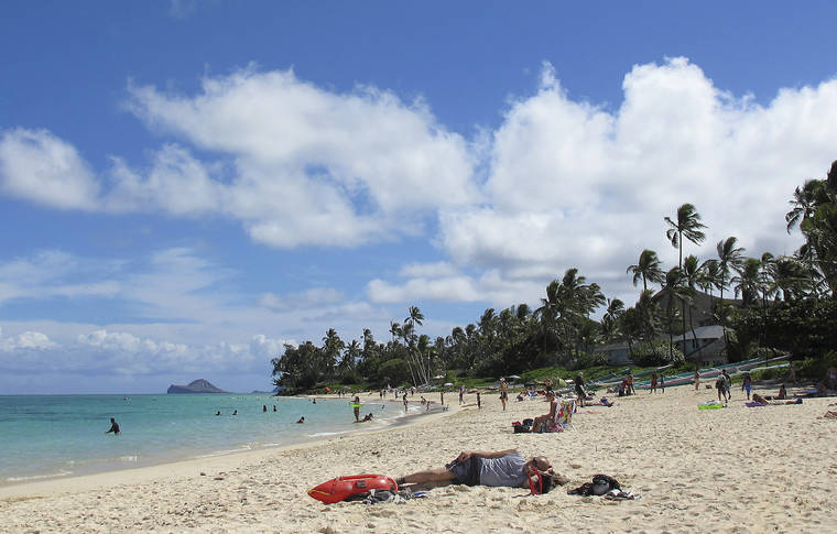 ASSOCIATED PRESS
                                This Oct. 29, 2013 file photo shows people at Lanikai Beach, a popular neighborhood for vacation rentals, in Kailua. Airbnb Inc. is agreeing to provide Hawaii with records for many of its island hosts as the state tries to track down vacation rental operators who haven’t been paying their taxes.