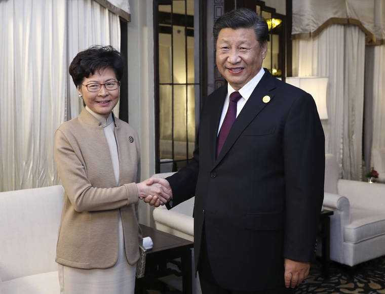 XINHUA VIA AP
                                Chinese President Xi Jinping poses with Hong Kong Chief Executive Carrie Lam for a photo during a meeting in Shanghai, China.