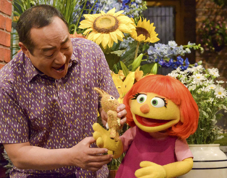 COURTESY SESAME WORKSHOP
                                “Seasame Street” castmember Alan Muraoka, left, with Julia, an autistic muppet character. The popular children’s TV show is celebrating its 50th season this year.
