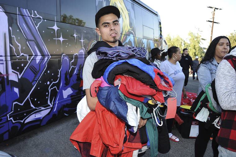 RICHARD SHOTWELL/INVISION/ASSOCIATED PRESS
                                Justin Quintna, of Los Angeles, shopped at Chris Brown’s yard sale at Brown’s home in the Tarzana neighborhood of the San Fernando Valley on Wednesday in Los Angeles.