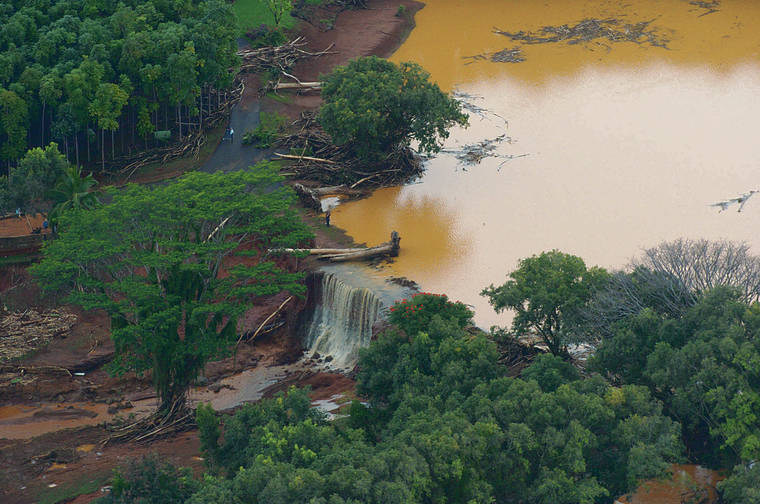 BRUCE ASATO / 2006
                                Water flows over a breach in an earthen dam at the Kaloko Reservoir in the northeast part of Kauai in Lilhue, Hawaii. An Associated Press investigation shows that virtually every one of Hawaii’s 130 state-regulated dams are considered high hazard, meaning they could cause death if they were to fail.