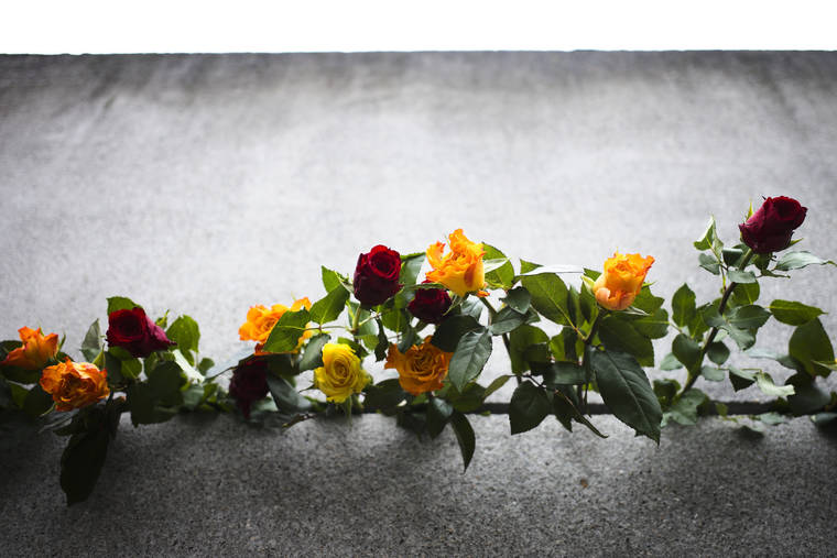 ASSOCIATED PRESS
                                Flowers stuck in remains of the Berlin Wall during a commemoration ceremony to celebrate the 30th anniversary of the fall of the Berlin Wall at the Wall memorial site at Bernauer Strasse in Berlin.