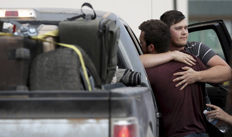 ARIZONA DAILY STAR VIA AP
                                Cole Langford, left, and Hayden Spenct, of the Mormon colony in La Mora, Mexico, hug at a gas station in Douglas, Ariz., today.