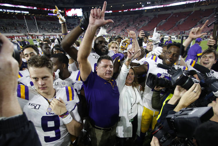 ASSOCIATED PRESS
                                LSU head coach Ed Orgeron celebrates with his players after defeating Alabama 46-41 in an NCAA college football game on Saturday in Tuscaloosa, Ala.