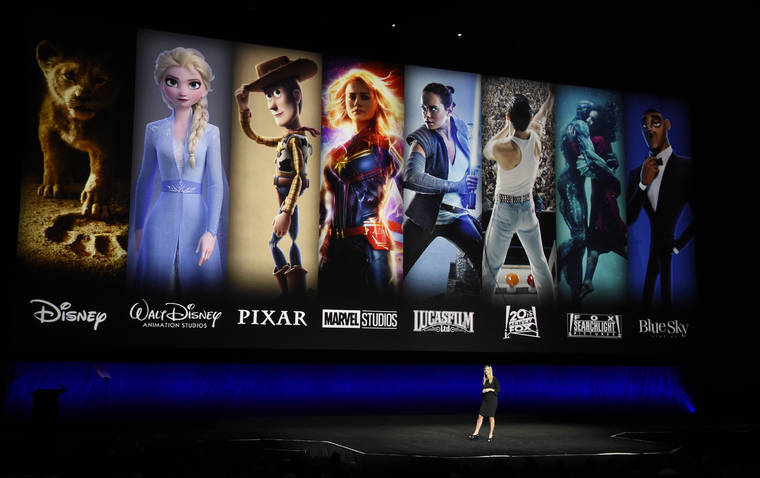ASSOCIATED PRESS
                                Characters from Disney and Fox movies are displayed behind Cathleen Taff, president of distribution, franchise management, business and audience insight for Walt Disney Studios at CinemaCon 2019 in April.