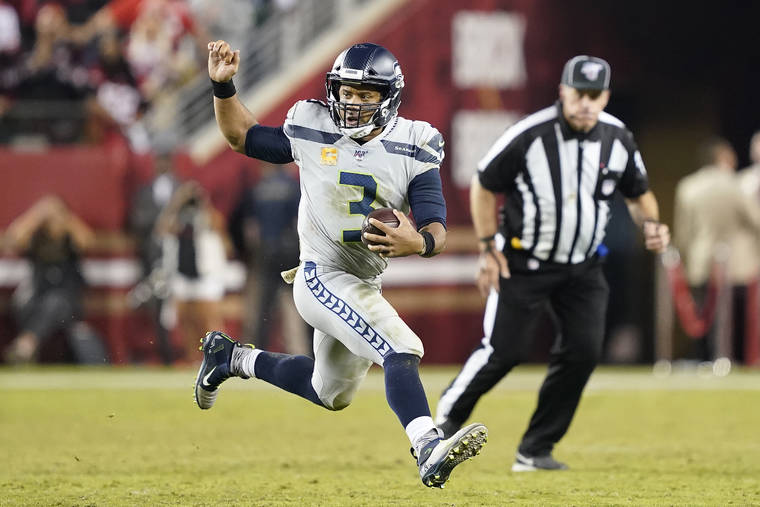 ASSOCIATED PRESS
                                Seattle Seahawks quarterback Russell Wilson ran the ball against the San Francisco 49ers during the second half of a game in Santa Clara, Calif., Monday.
