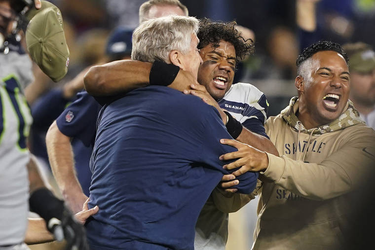 ASSOCIATED PRESS
                                Seattle Seahawks head coach Pete Carroll, left, celebrated with quarterback Russell Wilson, center, after the Seahawks defeated the San Francisco 49ers 27-24 in overtime in Santa Clara, Calif., Monday.