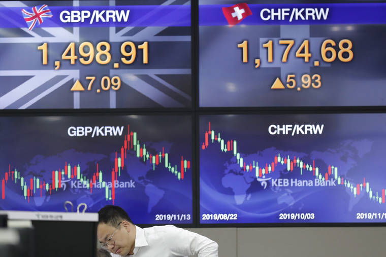ASSOCIATED PRESS
                                A currency trader works near the screens showing the foreign exchange rates at the foreign exchange dealing room in Seoul, South Korea.