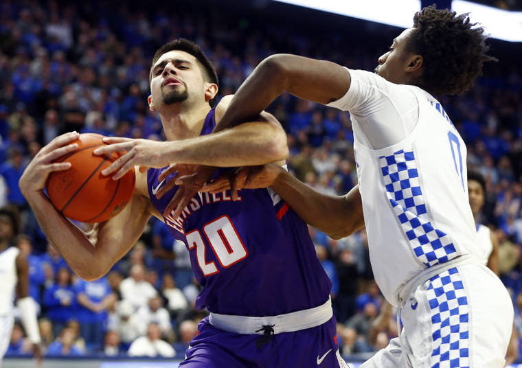 ASSOCIATED PRESS
                                Evansville’s Sam Cunliffe, left, is fouled by Kentucky’s Ashton Hagans, right, late in the second half of an NCAA college basketball game in Lexington, Ky., on Tuesday. Evansville won 67-64.