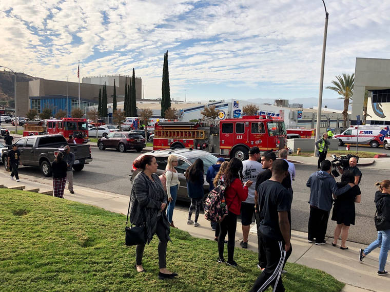 ASSOCIATED PRESS
                                People waited for students and updates outside of Saugus High School after reports of a shooting, today, in Santa Clarita, Calif.