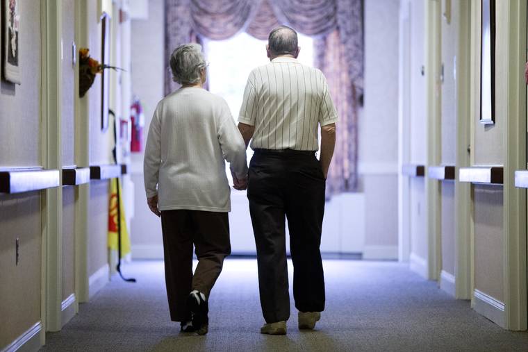 ASSOCIATED PRESS / 2015
                                A senior couple walks down a hall in November 2015 in Easton, Pa. Research released today suggested many American adults inaccurately estimate their chances for developing dementia and do useless things to prevent it.