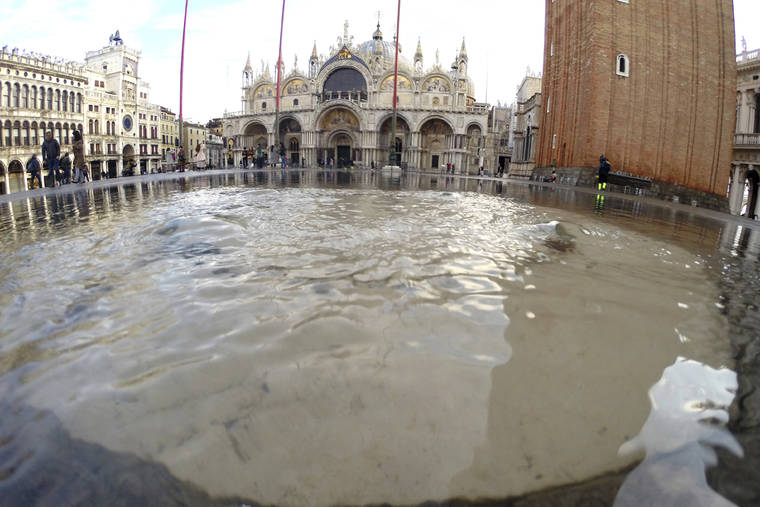 ASSOCIATED PRESS
                                Water starts rising again in St. Mark square in Venice, Italy. High tidal waters returned to Venice on Saturday, four days after the city experienced its worst flooding in 50 years.