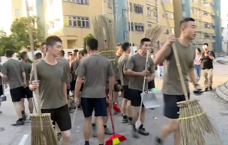 TELEVISION BROADCASTS LIMITED HONG KONG VIA AP
                                In this image made from video, People’s Liberation Army soldiers arrive to clean up the protest area at Hong Kong Baptist University in Hong Kong.
