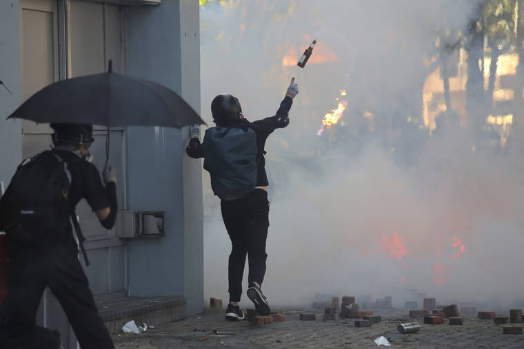 ASSOCIATED PRESS
                                A protestor hurls a molotov cocktail during a confrontation with police at the Hong Kong Polytechnic University in Hong Kong.
