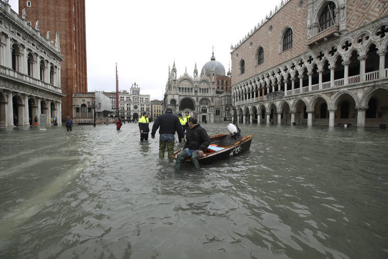 ASSOCIATED PRESS
                                A man sits on a small boat in a flooded St.Mark square in Venice, Italy, today. Venetians are bracing for the prospect of another exceptional tide in a season that is setting new records. Officials are forecasting a 1.6 meter (5 feet, 2 inches) surge of water today through the lagoon city.