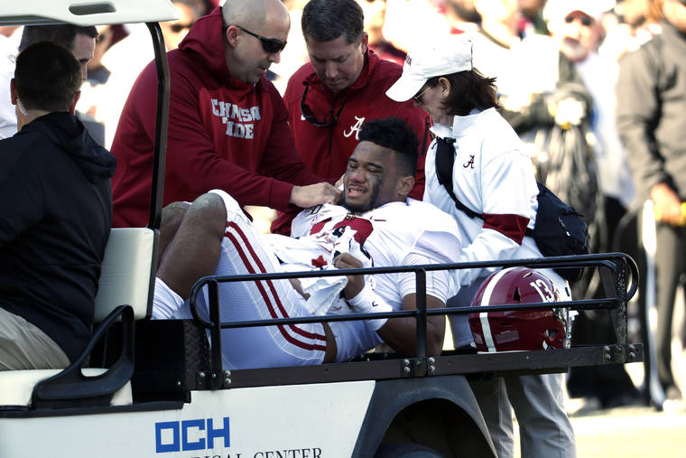 ASSOCIATED PRESS
                                Alabama quarterback Tua Tagovailoa is carted off the field after getting injured in the first half.