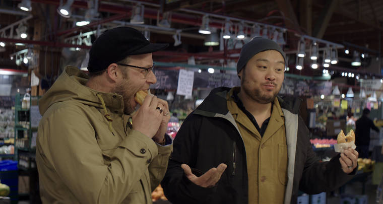 COURTESY NETFLIX
                                Chef David Chang, right, and actor Seth Rogen eating donuts at Lee’s Donuts in Vancouver, Canada, in a scene from the Netflix series, “Breakfast, Lunch & Dinner.”
