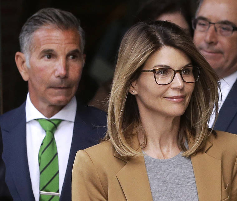ASSOCIATED PRESS
                                Actress Lori Loughlin, front, and husband, clothing designer Mossimo Giannulli, left, leave federal court in Boston after facing charges in a nationwide college admissions bribery scandal on April 3. The couple are fighting expanded charges against them in the college admissions bribery scandal.