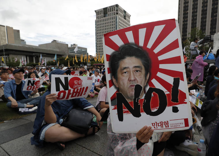 ASSOCIATED PRESS
                                A protester held an image of Japanese Prime Minister Shinzo Abe, Aug. 15, during a rally denouncing Abe and also demanding the South Korean government to abolish the General Security of Military Information Agreement, or GSOMIA, an intelligence-sharing agreement between South Korea and Japan, in downtown Seoul, South Korea.