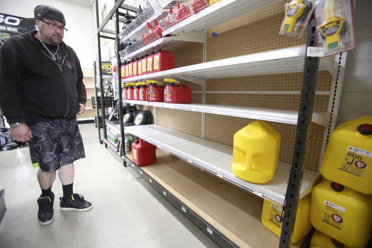ASSOCIATED PRESS
                                Grass Valley’s Dionicio Torres looks at the gas can selection before taking the last 5-gallon gas can on the shelves at B&C Ace Home & Garden Center, in Grass Valley, Calif., Tuesday, in preparation of today’s planned public safety power shutdown.