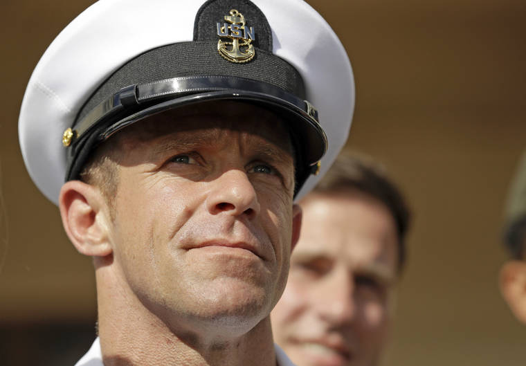ASSOCIATED PRESS / JULY 2
                                Navy Special Operations Chief Edward Gallagher leaves a military court on Naval Base San Diego. The attorney for Gallagher, convicted of posing with a dead captive in Iraq, says the Navy is trying to remove the special operations chief from the elite fighting force in retaliation for President Donald Trump restoring his rank. Defense attorney Timothy Parlatore said the Navy is holding a review board proceeding to remove Edward Gallagher’s Trident pin and summoned him to meet with the SEAL leadership.