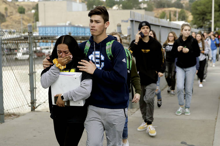 ASSOCIATED PRESS
                                Students were escorted out of Saugus High School after reports of a shooting, today, in Santa Clarita, Calif.