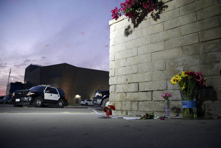 ASSOCIATED PRESS
                                Flowers are placed in front of Saugus High School in the aftermath of a shooting today in Santa Clarita, Calif.
