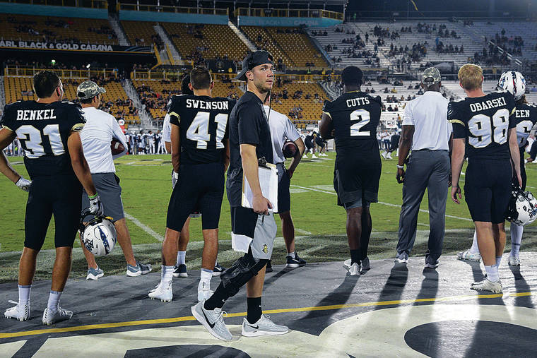 ASSOCIATED PRESS
                                Central Florida quarterback McKenzie Milton, center, walked along the sideline during the second half of a game against Connecticut in Orlando, Fla., on Sept. 28.