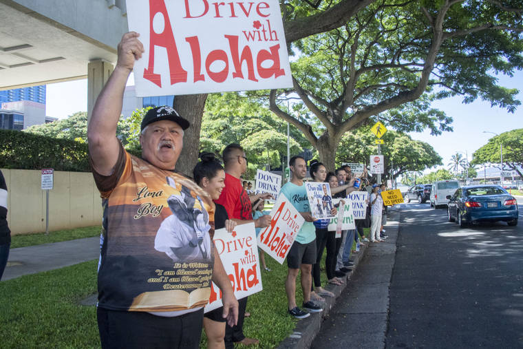 CRAIG T. KOJIMA/ CKOJIMA@STARADVERTISER.COM
                                Edward Werner, father of Kaulana Werner, held a sign outside of the court after a judge sentenced Myisha Lee Armitage, 26, to 10 years in prison today.