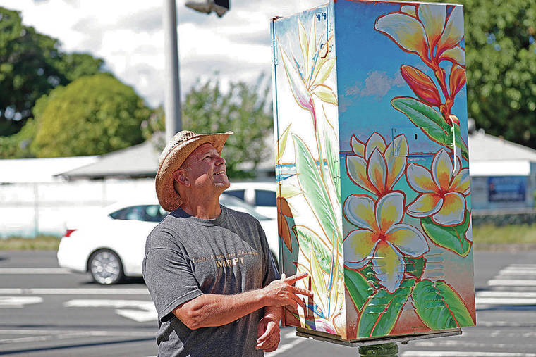 JAMM AQUINO / JAQUINO@STARADVERTISER.COM
                                Patrick Ching flew in from Kauai to paint one of the boxes around Kailua as part of a comprehensive public project.