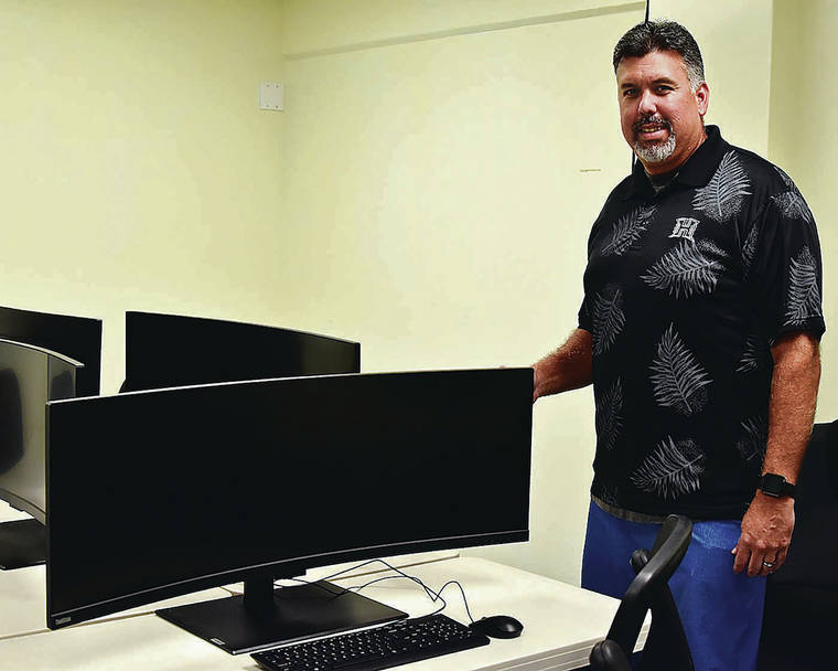 RODNEY S. YAP / SPECIAL TO THE STAR-ADVERTISER
                                Al Paschoal, University of Hawaii-Maui College director of student life, stood next to the school’s brandnew gaming machines last week in preparation for the second college tryout on Friday.