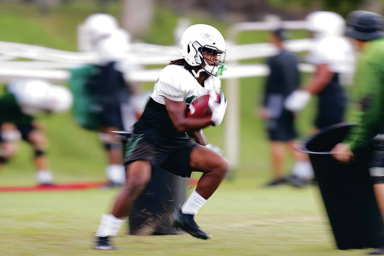 JAMM AQUINO / JAQUINO@STARADVERTISER.COM
                                Hawaii running back Miles Reed ran through a drill during the Rainbow Warrior football team’s practice on Wednesday on campus. Reed enters Saturday’s game at UNLV with a team-high 569 rushing yards and six touchdowns this season.