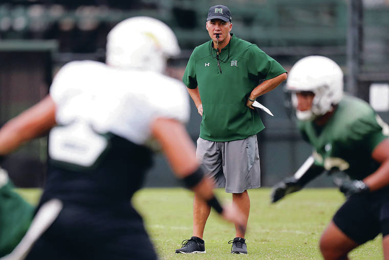 ANDREW LEE / SPECIAL TO THE STAR-ADVERTISER
                                Defensive coordinator Corey Batoon watched his unit run through drills during Wednesday’s practice at UH.