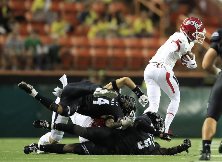 JAMM AQUINO / JAQUINO@STARADVERTISER.COM
                                Fresno State wide receiver Jalen Cropper (5) gets past Hawaii defensive back Kai Kaneshiro (24) and defensive back Khoury Bethley (5) on the way to a touchdown tonight at Aloha Stadium.